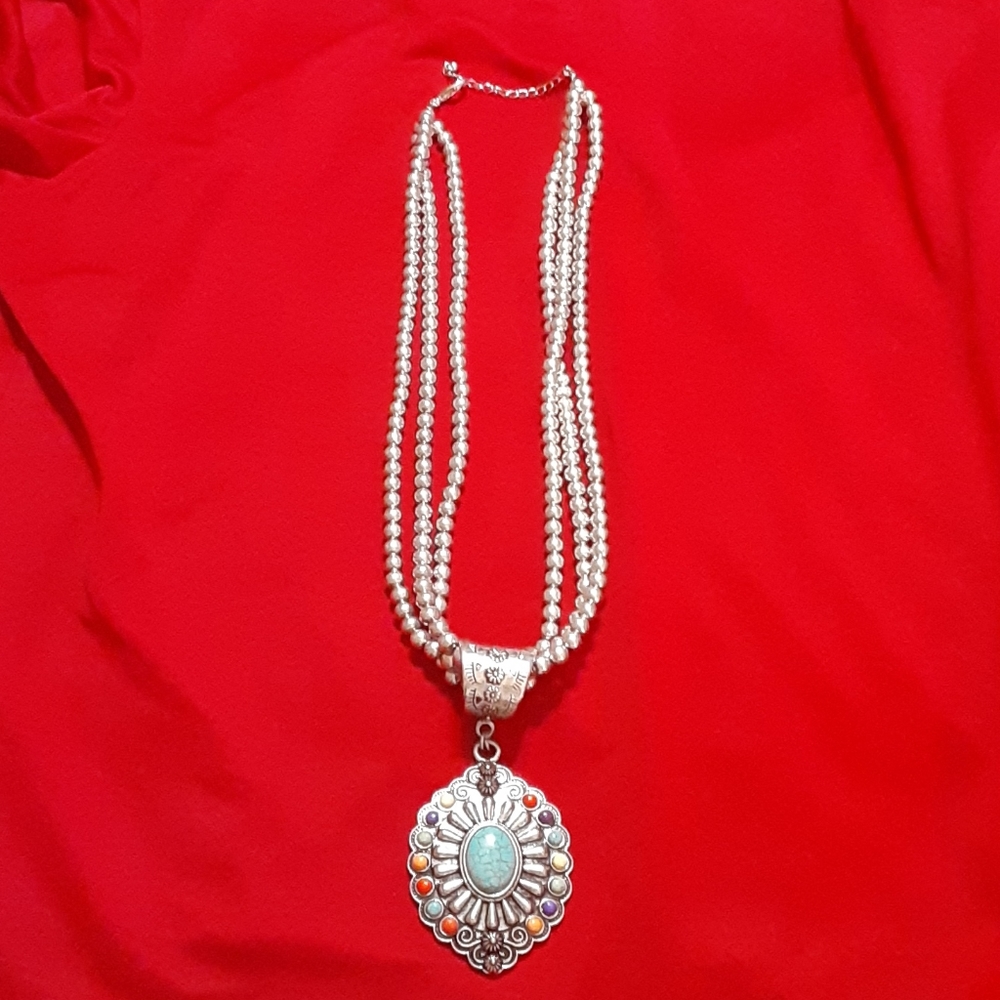Silver necklace with multi-colored stone pendant